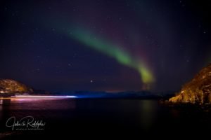 ferry low speed passing in fjord norway aurora boreal